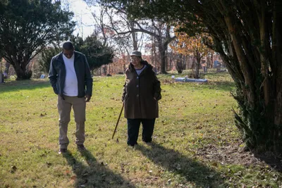 Harry and Janis Ivory walk through the cemetery where their parents are buried in Rendville, OH. Janis, her brother Harry and others are working to revitalize the old coal town.